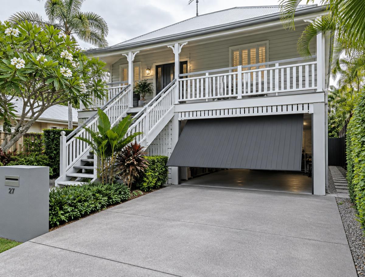 Single-panel Colorbond steel tilt garage door in grey opening outward over a clear driveway